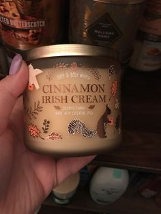 a hand holding up a jar of cinnamon irish cream