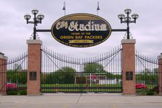 the entrance to city stadium home of the green bay packers, in front of an iron gate