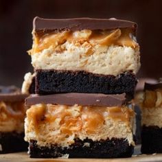 chocolate and caramel cheesecake bars stacked on top of each other