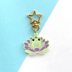 a cute little frog with a star on it's head sitting in a lotus flower