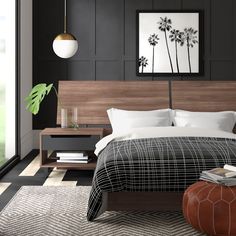 a bedroom with black walls and white bedding