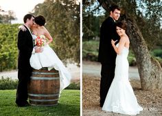 a bride and groom standing next to a barrel in front of a tree at their wedding