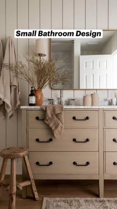 a bathroom with white walls and wooden furniture, including a large mirror over the sink