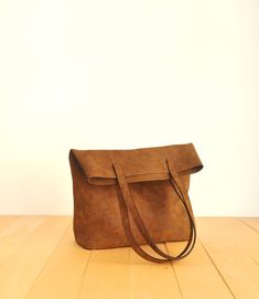 "This tote bag is made of high quality vegan leather in brown. It is soft and lightweight but durable. It has a rustic, distressed look. It has two interior pockets. It has a slouchy silhouette and plenty of room for your daily needs. Measurements: 41 x 31 x 14 cm IMPORTANT! Your orders between 7-25 August will be shipped on August 28. Delivery takes 2-5 days to the US, Canada, Australia and Europe; in 3-7 days to rest of the world after shipping. For other color options you can check \"Totes\" Yellow Tote Bag, Vegan Tote Bag, Red Tote Bag, Brown Tote Bag, Purple Backpack, Purple Bag, Vegan Handbags, Red Tote, Brown Tote