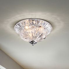 a light that is on the ceiling in a room with white walls and flooring