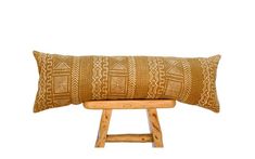 a wooden bench with a pillow on it