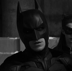 batman and catwoman standing next to each other