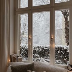 a living room filled with lots of windows covered in snow next to a window sill