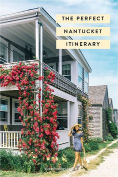 a woman is standing in front of a house with flowers on the porch and balcony