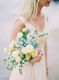 a woman in a dress holding a bouquet of flowers