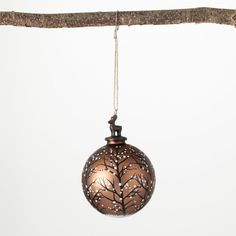 a brown ornament hanging from a tree branch