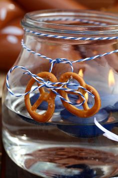 a jar filled with water and some pretzels