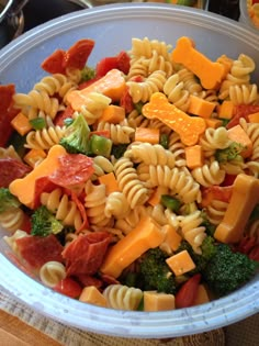 a bowl filled with pasta, broccoli and cheese