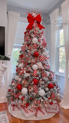 a decorated christmas tree with candy canes and ornaments in red, white and silver