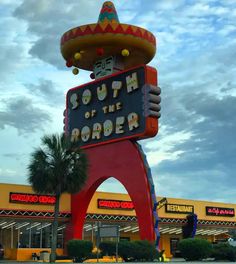 a large sign that says south of the border in front of a building with a mexican hat on top