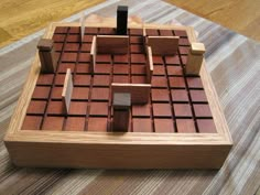 a wooden puzzle on top of a rug