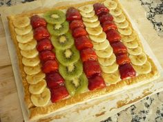 an american flag made out of sliced bananas and kiwis on a cutting board