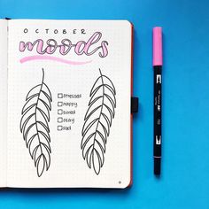 an open notebook with the words october models written on it and a pink marker next to it