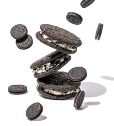 an oreo sandwich with ice cream and cookies falling from the top to the bottom