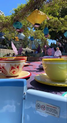 colorful bowls and plates on display at an amusement park