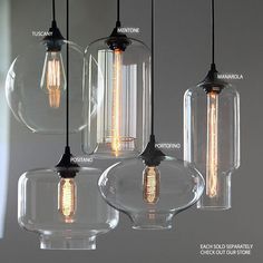 three clear glass pendant lights hanging from a chandelier with labeled labels on them