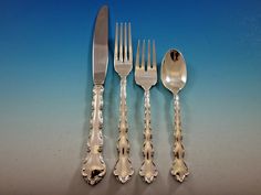 five forks, two spoons and one knife with bead ends on a blue background