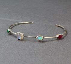 Lovely feminine Sleek 4 stone station Cuff Bracelet.Made of Solid 925 Sterling Silver is studded with genuine Emerald,Moonstone,Tourmaline and Ethiopian Opal .It is an Adjustable Bangle Bracelet,and available in small,medium and large sizes.This is a cute dainty cuff bracelet for your Wife/Girl Friend on your Anniversary.Lovely cuff for your daughter's Graduation.Good comfortable and light weight for women of all ages.. SKU -ETB1052 Style - Cuff Bracelet Gemstone - Emerald.Moonstone.Tourmaline.E Stone And Silver Ring, Silver Bracelets With Stones, Cuff Bracelet With Stones, Jewelry Gifts For Women, Silver Jewelry Inspiration, Dainty Silver Bracelets, Silver Opal Jewelry, Silver Cuff Bracelets, Wild Jewelry