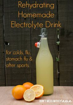 a bottle of homemade electrolyte drink next to oranges