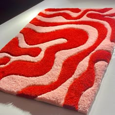 a red and white rug on top of a table