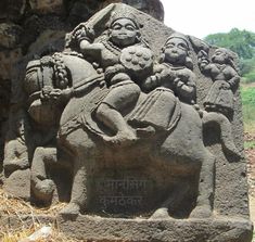 a stone sculpture with an elephant and people on it