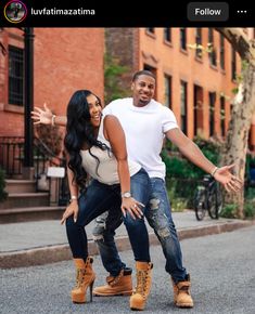 a man and woman posing for a photo in the street