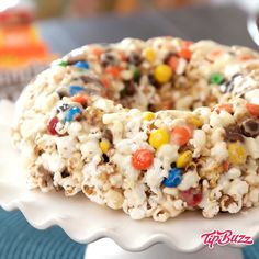 a white plate topped with a cereal krispy kreme donut covered in candy