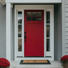 a red front door on a gray house