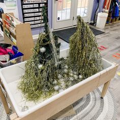 two fake trees sitting on top of a white tray