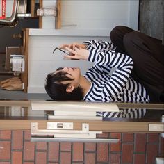 a man laying on the ground using his cell phone