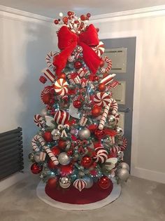 a christmas tree decorated with candy canes and bows