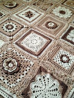 a crocheted blanket that is on top of a table