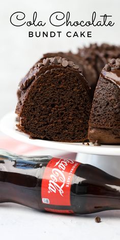 a chocolate bundt cake on a white plate with a coca - cola bottle