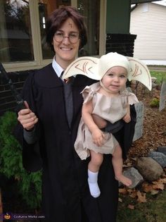 a woman holding a baby wearing a harry potter costume in front of her is an instagram