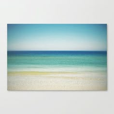 an ocean view with blue sky and white sand on the beach canvas wall art print