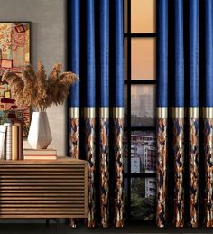 a living room scene with focus on the window curtain and curtains that are blue, gold and brown