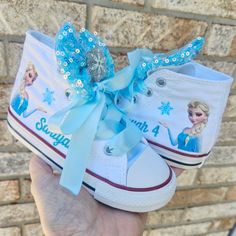 Elsa on each shoe with a sparkly snowflake and name and blue sparkle bows on the tongues with snowflake center as show.  Light blue double faced sating laces/ties. Converse For Girls, Princess Toys, School Theme, Girls Converse, Frozen Theme, Blue Sparkle, Princess Elsa, Sneakers Athletic, Blue Sparkles