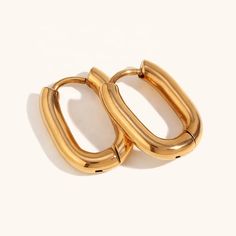 Discover a must-have in every jewelry collection with our Classic Oval Huggie Hoop Earrings - the perfect combination of minimalism and luxury. Made with 18k gold plated stainless steel, these Mini Gold Hoop Earrings are a versatile and timeless accessory that will elevate any outfit. Add a touch of elegance and sophistication to your look with these must-have Huggie Earrings. Crystal Ear Cuff, Mini Gold, Huggie Earrings, Timeless Accessories, Huggie Hoop Earrings, Wedding Night, Everyday Earrings, Pearl Studs, Gold Hoop