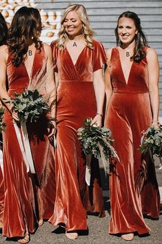 the bridesmaids are wearing red velvet dresses