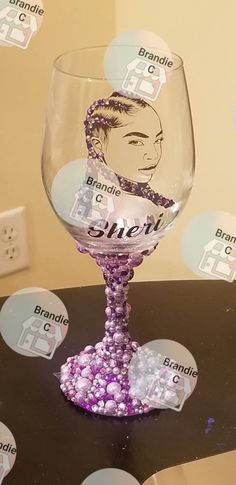 there is a wine glass that has been decorated with the image of a woman's face