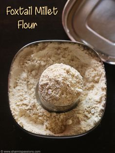 a metal bowl filled with flour next to a baking pan