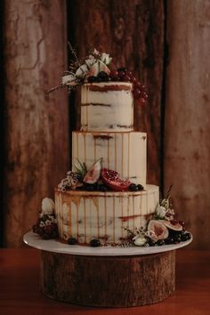 a three tiered cake with white frosting and flowers