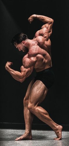 a man standing on one leg and flexing his muscles