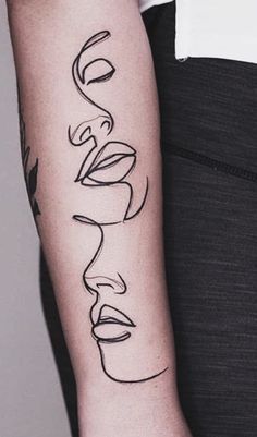 a woman's arm with the word love tattooed on it