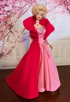 a barbie doll wearing a pink and red dress